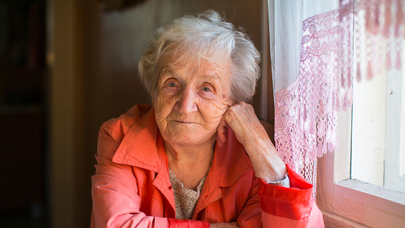 Picture of older woman wearing a red coat